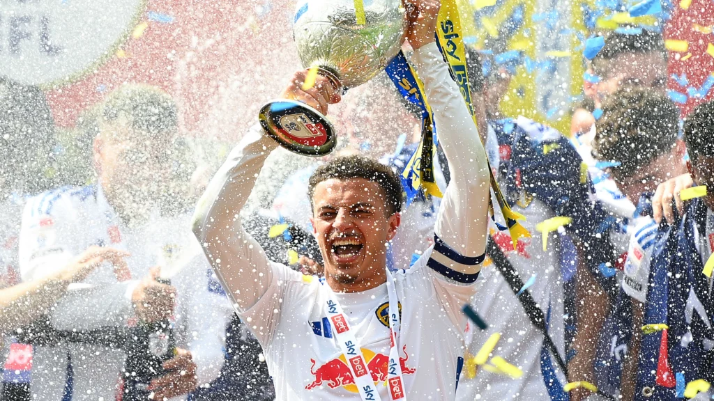 Ethan Ampadu lifting the Championship trophy with Leeds United