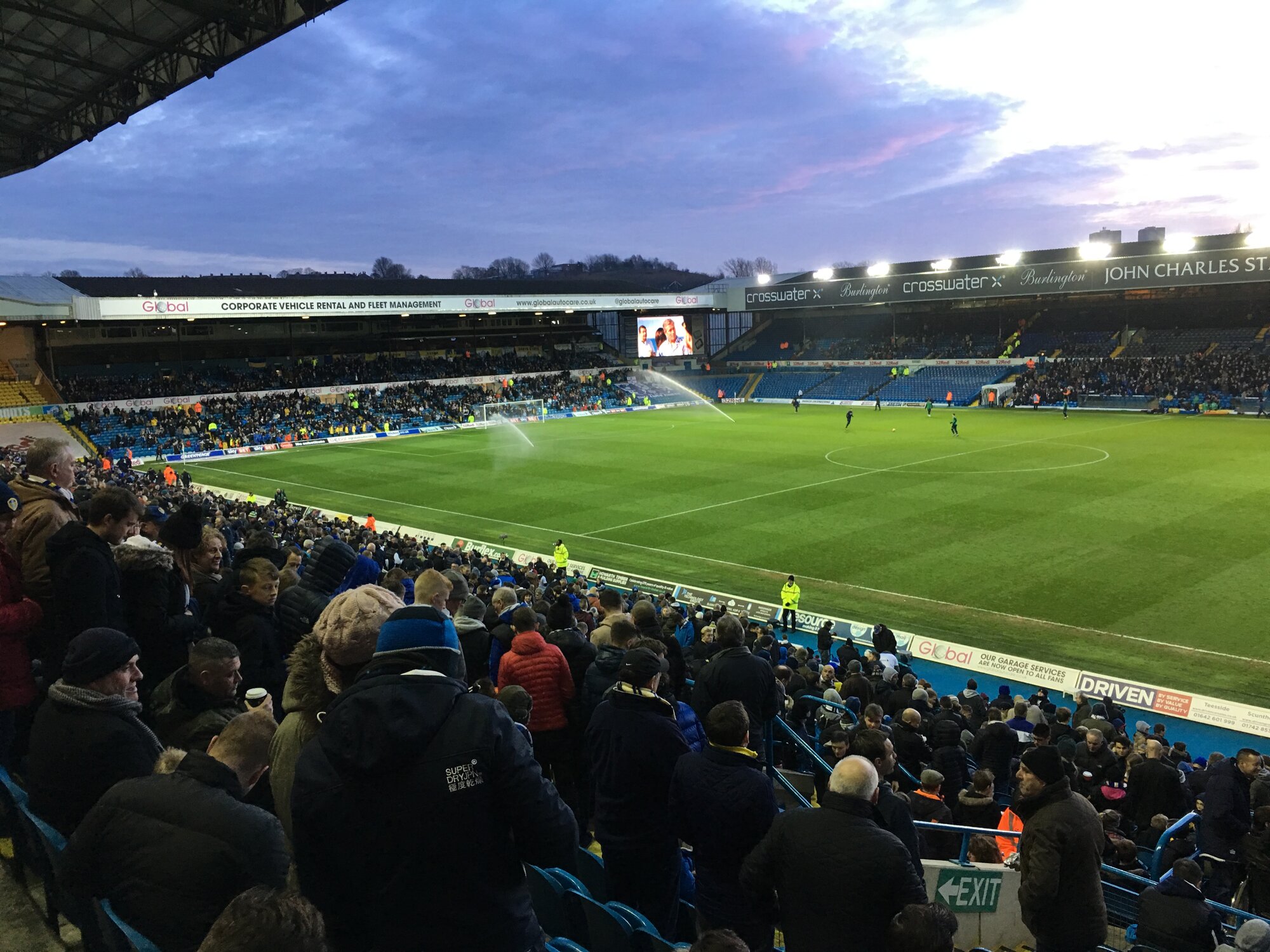 Elland Road stadium on a match day, seen from the stand, with the pitch and the John Charles Stand behind